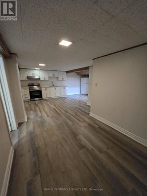 Toronto (L'amoreaux) apartment for rent - A room with wooden flooring and white walls.