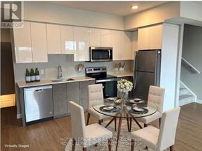 Guelph (Riverside Park) townhouse for rent - A kitchen with a table and chairs in front of it.