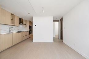 Surrey apartment for rent - A kitchen with wooden cabinets and a white countertop.
