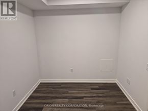 Vaughan (Vaughan Corporate Centre) condo for rent - A room with a wooden floor and white walls.