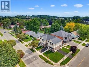Kitchener apartment for rent - A realtor logo is on a picture of a suburban neighborhood.
