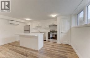 Kitchener apartment for rent - A white kitchen with a large island in the middle.