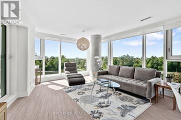 Ottawa condo for rent - A living room with a couch, chairs, and a table with a glass top.