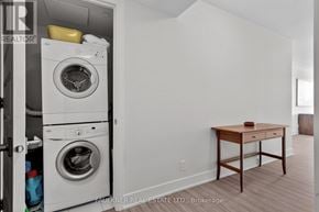 Ottawa condo for rent - A laundry room with a washer and dryer in it.