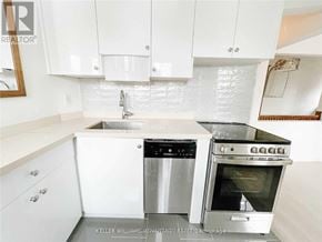 Toronto (Danforth Village-East York) apartment for rent - A white kitchen with a stainless steel dishwasher and oven.
