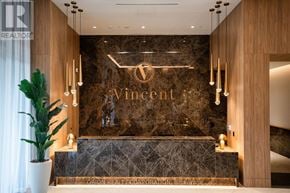 Vaughan (Vaughan Corporate Centre) condo for rent - A reception area with a large Vincent logo on the wall.