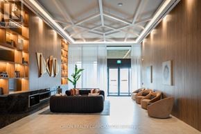 Vaughan (Vaughan Corporate Centre) condo for rent - A modern office lobby with a reception desk and comfortable seating.