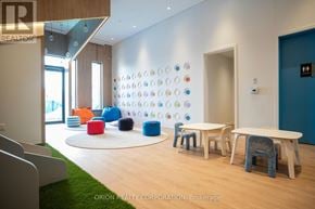 Vaughan (Vaughan Corporate Centre) condo for rent - A room with a white table and blue chairs.