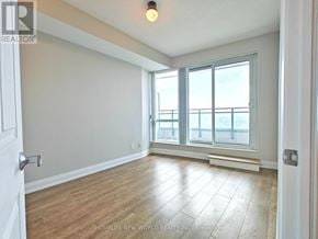 Toronto (Willowdale East) condo for rent - A room with a large window and wooden flooring.