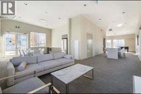 Richmond townhouse for rent - A spacious room with a grey sofa and a coffee table.