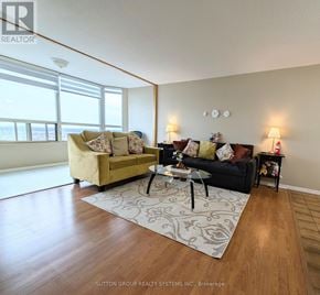 Mississauga (City Centre) condo for rent - A living room with a couch, a coffee table, and a rug.