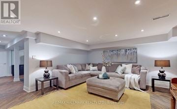 Toronto (Birchcliffe-Cliffside) apartment for rent - A well-lit living room with a grey sofa and a coffee table.