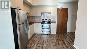 Markham (Village Green-South Unionville) condo for rent - A kitchen with a refrigerator, oven, and cabinets.