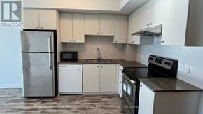 Markham (Village Green-South Unionville) condo for rent - A kitchen with a refrigerator, microwave, oven, and dishwasher.