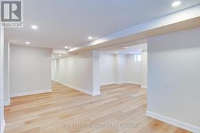 Fort Erie (Central) apartment for rent - A spacious room with wooden flooring and white walls.