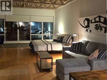 Vancouver apartment for rent - A living room with a grey couch and a coffee table.