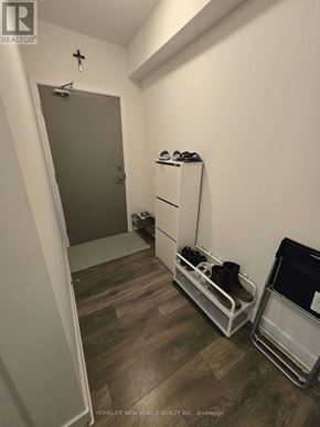 Toronto (Don Valley Village) condo for rent - A hallway with a pair of shoes on a shelf and a refrigerator.