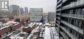 Toronto (Bay Street Corridor) condo for rent - A cityscape with buildings and a Realty sign.