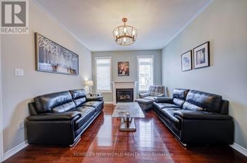Markham (Cornell) apartment for rent - A living room with black leather couches and a fireplace.