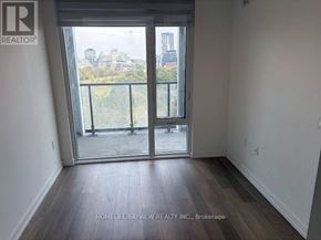 Toronto (Moss Park) condo for rent - A room with a view of the city through a large window.