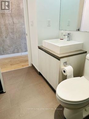 Toronto (Waterfront Communities) condo for rent - A white toilet with a white sink and a roll of toilet paper on the counter.