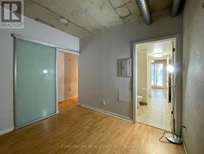 Toronto (Little Portugal) condo for rent - A room with a glass door and a wooden floor.