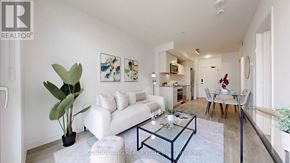 Toronto (Church-Yonge Corridor) condo for rent - A living room with a white sofa and a glass coffee table.