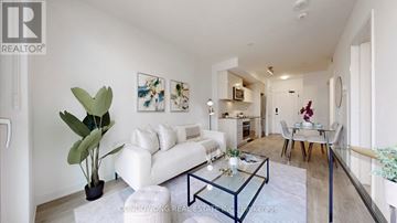 Toronto (Church-Yonge Corridor) condo for rent - A living room with a white sofa and a glass coffee table.