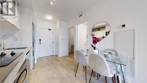 Toronto (Church-Yonge Corridor) condo for rent - A modern kitchen with a dining area in the background.