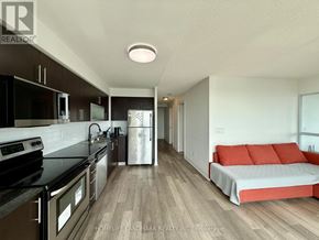 Toronto (Bendale) condo for rent - A modern kitchen with a refrigerator, oven, and microwave.