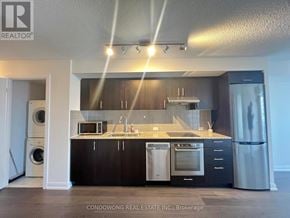 Toronto (Agincourt South-Malvern West) condo for rent - A modern kitchen with black cabinets and stainless steel appliances.