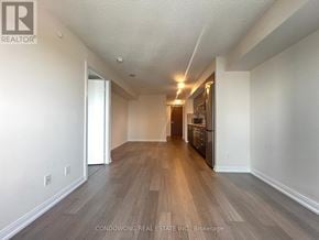 Toronto (Agincourt South-Malvern West) condo for rent - A spacious room with wood flooring and white walls.
