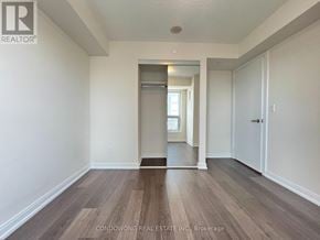 Toronto (Agincourt South-Malvern West) condo for rent - A room with wood flooring and white walls, with a doorway leading to another room.
