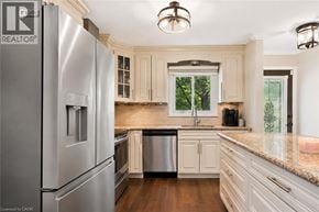 Guelph apartment for rent - A modern kitchen with a stainless steel refrigerator and wooden floors.