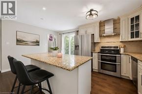 Guelph apartment for rent - A kitchen with a granite countertop and a framed picture on the wall.
