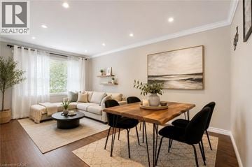 Guelph apartment for rent - A well-lit living room with a dining table and chairs.