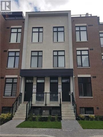 Vaughan (Sonoma Heights) townhouse for rent - A building with a black door and windows with white frames.