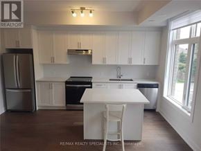 Vaughan (Sonoma Heights) townhouse for rent - A white kitchen with a refrigerator, oven, and sink.