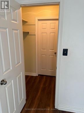 St. Catharines (Oakdale) condo for rent - A white door with a handle is in a room with wooden floors.