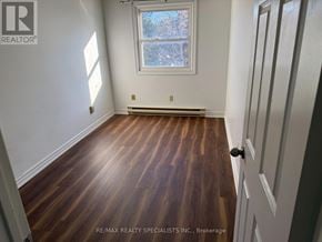 St. Catharines (Oakdale) condo for rent - A room with wooden floors and a window.