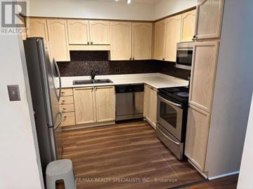 St. Catharines (Oakdale) condo for rent - A kitchen with wooden cabinets and stainless steel appliances.