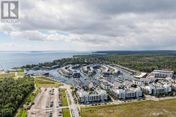 Innisfil condo for rent - A real estate brokerage logo is displayed on an aerial view of a waterfront property.