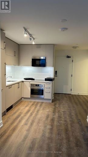 Markham (Unionville) condo for rent - A kitchen with wooden floors and white cabinets.