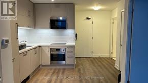 Markham (Unionville) condo for rent - A kitchen with a refrigerator, oven, and microwave.