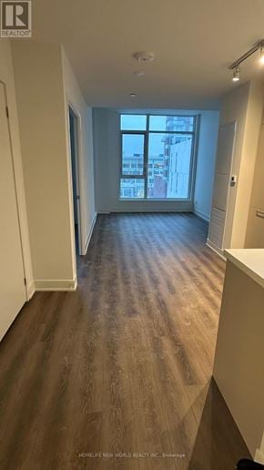 Markham (Unionville) condo for rent - A long hallway with wood floors and a window at the end.