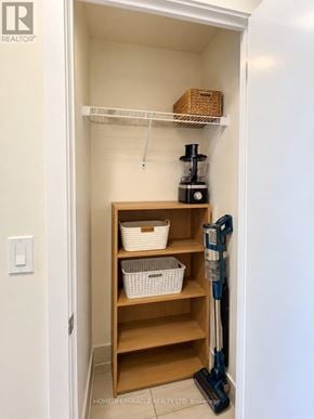 Toronto (Don Valley Village) condo for rent - A small pantry with a shelf and a vacuum cleaner.