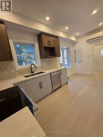 Toronto (Bendale) multi-family for rent - A kitchen with wooden cabinets and a white countertop.