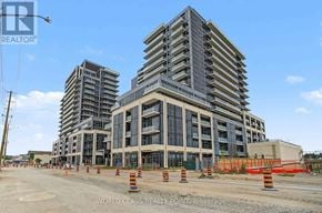 Milton (Om Old Milton) condo for rent - A large building under construction with orange cones around it.