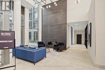 Milton (Om Old Milton) condo for rent - A living room with a blue couch and a sign that says "Millhouse".