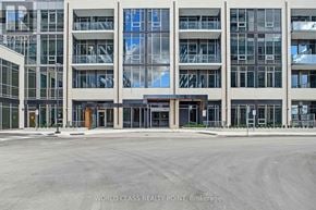 Milton (Om Old Milton) condo for rent - A large building with a glass facade and a parking lot in front.